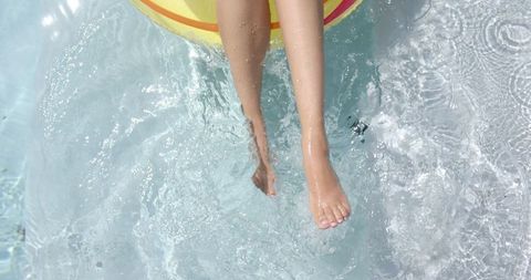 Relaxed summer pool day with inflatable ring and rippling water