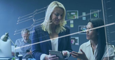 Professional Women Analyzing Business Data in Modern Office