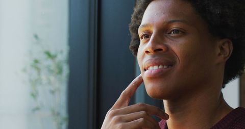 Contemplative African American Man Smiling Peacefully by Window - Download Free Stock Images Pikwizard.com