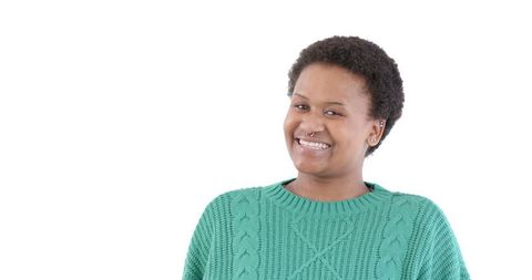 Smiling woman in green sweater with confident expression