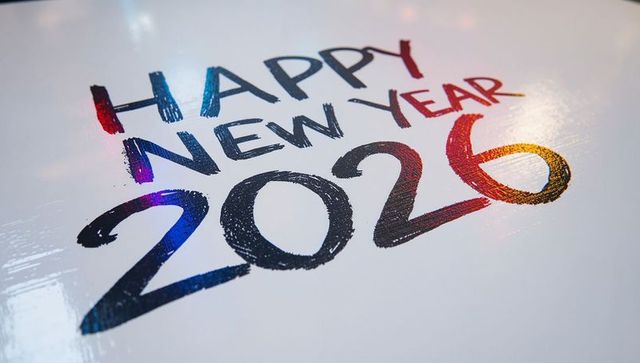 Glossy happy new year 2026 with iridescent foil typography reflecting rainbow highlights