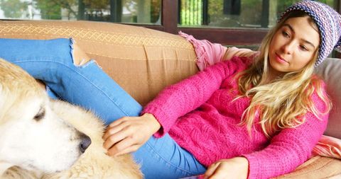 Caucasian Female Relaxing and Petting Her Dog at Home - Download Free Stock Images Pikwizard.com