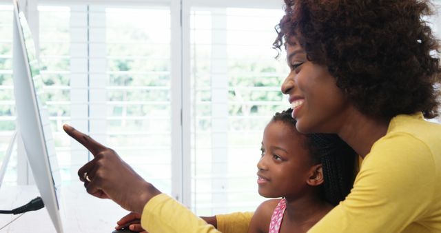 Mother and Daughter Using Computer Together Smiling - Download Free Stock Photos Pikwizard.com