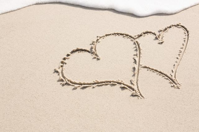 Two Intertwined Hearts Drawn on Sandy Beach - Download Free Stock Photos Pikwizard.com