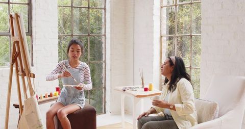 Diverse Female Artists Crafting in Bright Art Studio