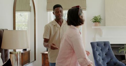 Diverse Friends Laughing Together in Bright Living Room
