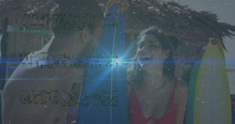 Joyful Couple with Surfboards on Tropical Beach