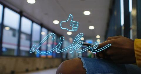 Neon like overlay on commuter tapping smartphone in urban transit station