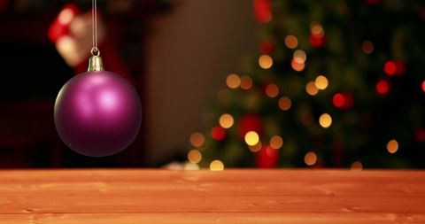 Purple Christmas Bauble with Festive Tree Bokeh Background - Download Free Stock Images Pikwizard.com