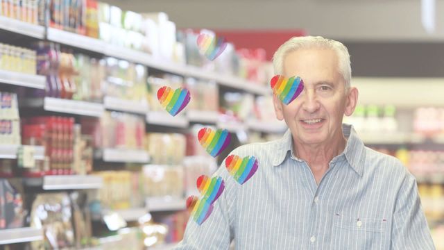 A cheerful senior man smiling in a grocery store aisle with a digital overlay of rainbow hearts reflecting a sense of joy and inclusion. Perfect for advertising positive retail experiences, promoting diversity in shopping environments, and illustrating the welcoming nature of customer service.