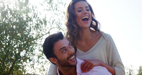 Joyful Couple Sharing Piggyback Ride Outdoors - Download Free Stock Images Pikwizard.com