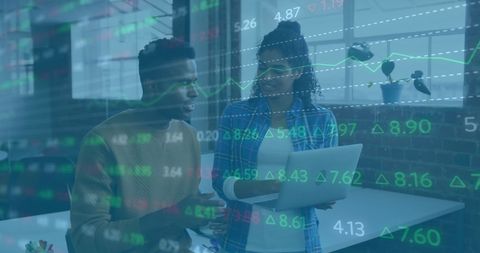 Diverse colleagues analyzing financial data trends in modern office