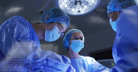Surgical Team Performing Complex Procedure in Modern Operating Room under Surgical Light