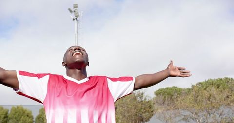 Soccer player celebrating victory outdoors with passion