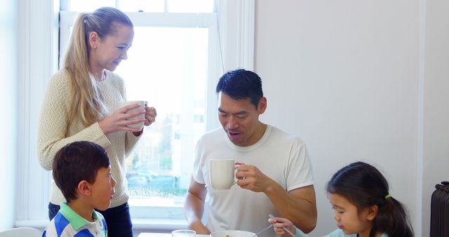 Happy multicultural family enjoying breakfast together - Download Free Stock Images Pikwizard.com