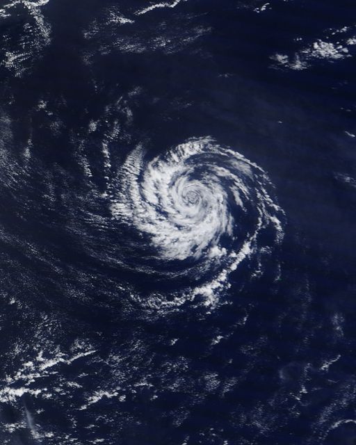 This image shows the spiral shape of a mini-cyclone over the western Pacific Ocean captured by NASA’s Terra satellite on July 17, 2013. Ideal for illustrating meteorological phenomena, satellite technology, and the dynamics of small-scale cyclonic storms. Suitable for educational materials, weather reports, and climate studies.