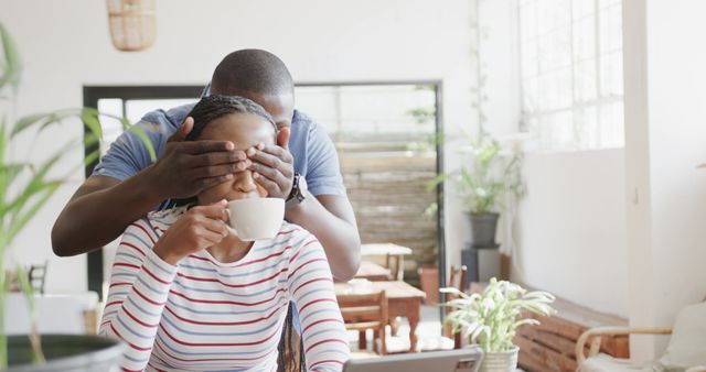 Man Surprising Woman Enjoying Coffee in Cozy Cafe - Download Free Stock Images Pikwizard.com