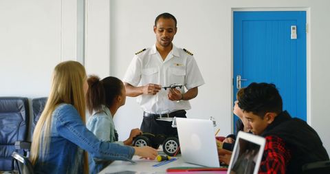 Pilot Educating Students on Model Airplane Mechanics - Download Free Stock Images Pikwizard.com