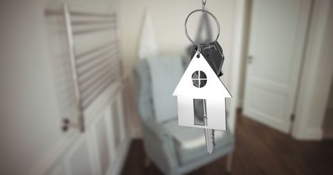 House-Shaped Keychain Dangling Key Set Symbolizes Home Ownership