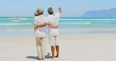 Senior Couple Embracing on a Tranquil Beach Day - Download Free Stock Images Pikwizard.com