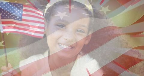 Smiling girl holding usa flag with stars and stripes overlay