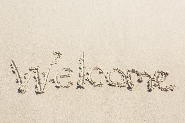 Welcome written on sand at beach