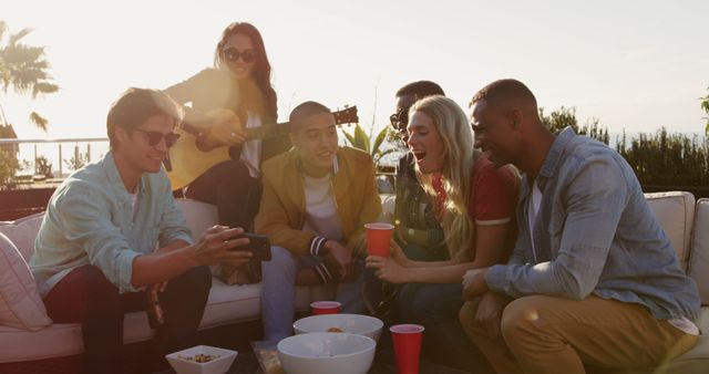 Friends Enjoying Outdoor Gathering at Sunset with Drinks - Download Free Stock Images Pikwizard.com