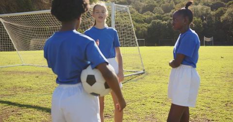 Diverse female youth soccer team on field