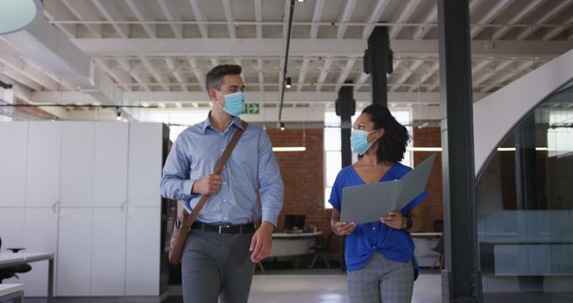 Colleagues Wearing Face Masks Walking in Modern Office - Download Free Stock Images Pikwizard.com