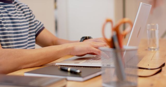 Close-up of Person Working on Laptop at Wooden Desk - Download Free Stock Images Pikwizard.com