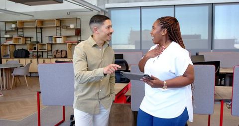 Diverse Colleagues Celebrating Success in Modern Office Setting