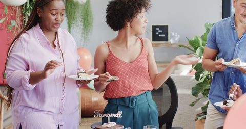 Colleagues enjoy fun office farewell party