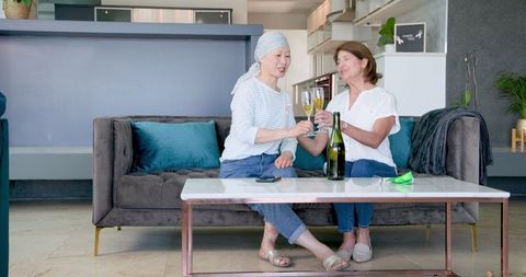 Senior female friends celebrating with champagne
