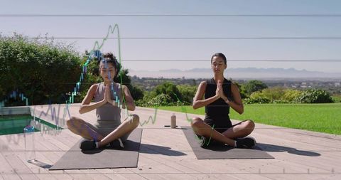 Sunrise yoga on wooden deck with financial chart overlay merging wellness and analytics