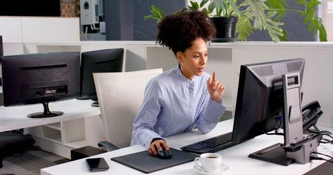 Focused Female Professional Using Computer in Modern Office - Download Free Stock Images Pikwizard.com