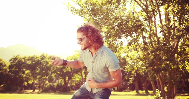 Smiling Man Enjoying Outdoor Time in Sunny Park - Download Free Stock Images Pikwizard.com