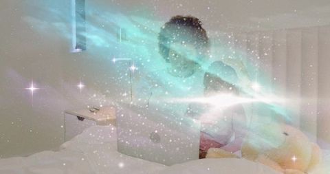 Mother and daughter watching laptop in cozy bed with starry aurora overlay, evening bonding