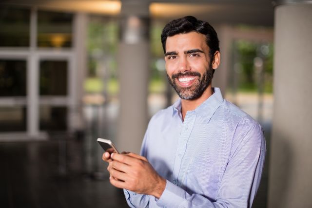 Portrait of business executive holding mobile phone
