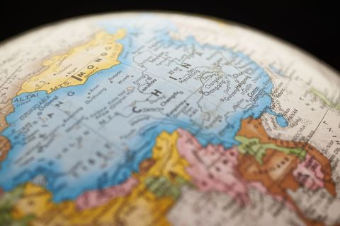 Vintage globe close-up showing china and east asia in soft focus for travel education