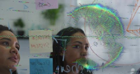 Teammates sketching diagram on glass board with sticky notes and digital glitch overlay