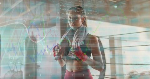 Woman boxer training with performance data overlay in gym boxing ring
