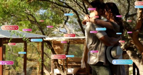 Couple sharing intimate embrace at scenic woodland retreat