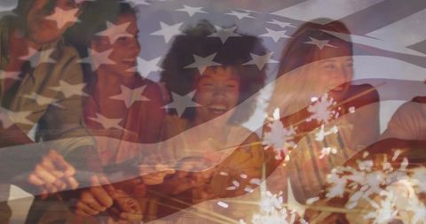 Multi-generation family celebrating independence day with sparklers and usa flag overlay