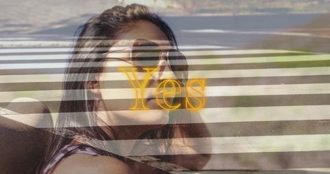 Reclining woman wearing aviator sunglasses with neon Yes text and crosswalk stripes double-exposure