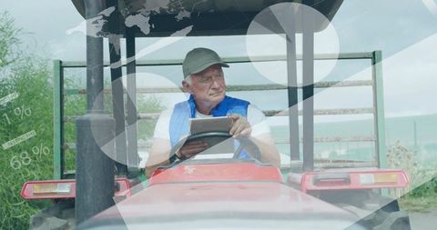 Senior farmer using tablet monitor agricultural data on tractor