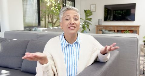 Mature Woman Relaxing on Sofa in Cozy Minimalist Living Room