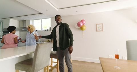 Friends Preparing Home Celebration With Drinks and Decorations