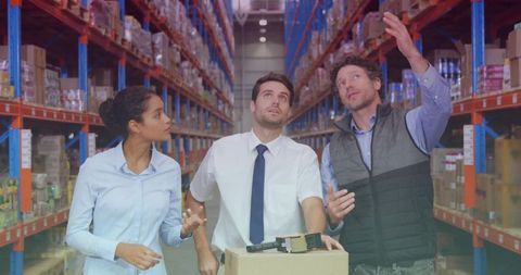 Warehouse team inspecting inventory on high racks with scanner and cardboard boxes