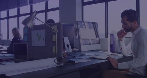 Focused Professional Man Concentrating in Modern Open Office