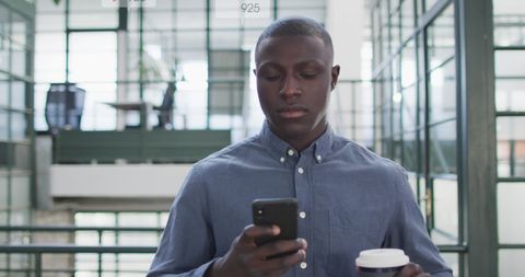 Businessman Engaging on Social Media While Having Coffee in Modern Office